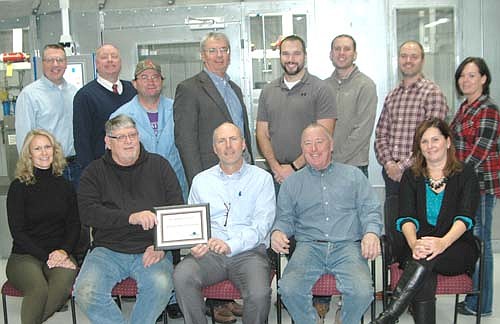 The city of Stewartville's Economic Development Authority presented Minnesota Medical Technologies with the EDA's Business Appreciation Award last week. Jim Kuisle, president of the EDA, seated second from left, and Mayor Jimmie-John King, a member of the EDA, second from right, present the award to Dave Jonas, president of Minnesota Medical Technologies, seated in center, at the company's Stewartville headquarters in the Schumann Business Park on Tuesday, Nov. 20. Other local officials and Minnesota Medical Technologies employees and executives include, seated from left, Sarah Grinde, vice president of marketing, research and development; and Lonnie Boe, office manager and secretary. Back row, from left, Rob Anglin, quality and regulatory; Bill Schimmel Jr., city administrator; Dave Mullenbach, dip line technician; Philip Conway, vice president of manufacturing; Matt Hodder, chief engineer; Jake Moskwa, accounting manager; Adam Wright, EDA member; and Chris York, quality manager.
