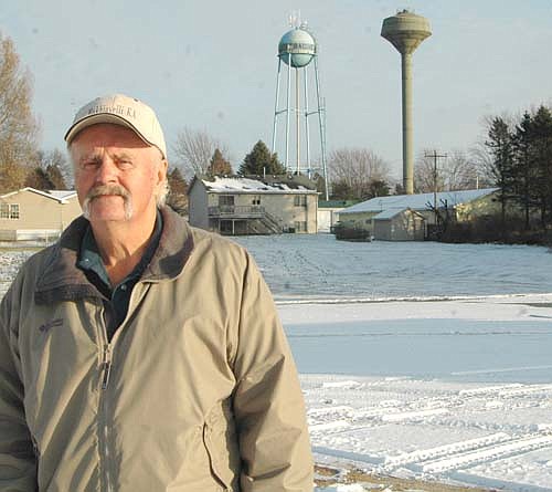  Deri Nordsving, mayor of Racine, poses in front of the city's new 140-foot tall water tower, at right, which stands side-by-side with the city's old water tower, which was built in 1962. The new tower is scheduled to be up and running by next June.