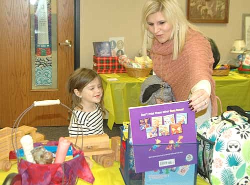 Lacie Tingesdal and her daughter Juliet, 5, were among the many local and area residents who browsed among the silent auction items at the Wee Care Learning Center's annual One-Stop Christmas Shop on Saturday morning, Nov. 17. Lacie said she and her children attend the event every year, partly because Dee Radtke, the director of Wee Care, is the Tingesdals' neighbor. "I like Wee Care," Lacie said. "I think it's a good program. The teachers are familiar faces in the community." The One-Stop Christmas Shop was also held on Friday evening, Nov. 16.