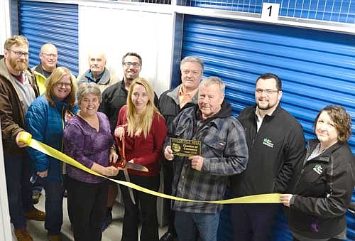 The Stewartville Area Chamber of Commerce welcomed Racine Storage to the Chamber with an ambassador visit and ribbon-cutting ceremony on Wednesday, Dec. 5. Allie Fryer, holding the ceremonial scissors, and Ken Smidt, holding the Chamber plaque, both of Racine Storage, celebrated the event with Chamber members and leaders, front row, from left, Ryan Ravenhorst of Insul-Seal, Gwen Ravenhorst, Chamber administrator; and Myrna Welter, Chamber membership coordinator. Back row, from left, Jeff Mullenbach of Smidt Companies, Deri Nordsving, mayor of the city of Racine, Jared Johnson of Anytime Fitness, and Dave Feddersen, Dylan Smallwood and Tabitha Hoffman of First Farmers&Merchants State Bank.