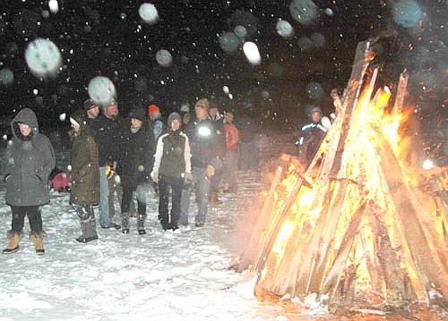 Residents who braved a snow and sleet storm warmed themselves near the bonfire at the Stewartville Area Chamber of Commerce's Winterfest celebration on Saturday, Dec. 1. 