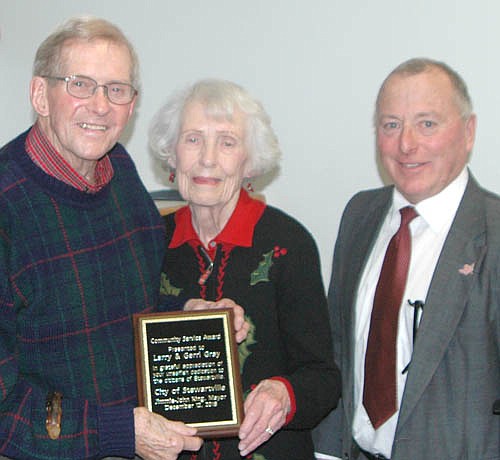 Larry and Gerri Gray accept the Mayor's Award for Community Service from Mayor Jimmie-John King, right. "I don't believe there could ever be anything written about the history of Stewartville that would not include these two," the mayor said.