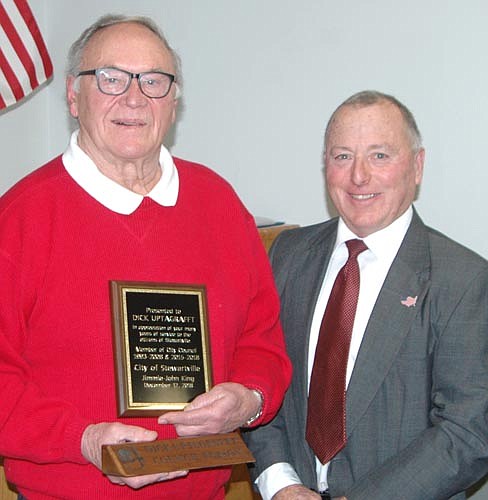 Dick Uptagrafft, left, who served five terms on the City Council and fell short in his effort to be re-elected to a sixth term, accepts recognition from Mayor Jimmie-John King, right, at the city's annual awards and recognition event last week.