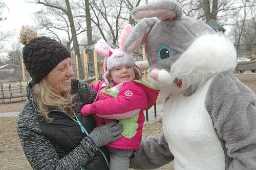 Ashlynn Anderson, 2, of Stewartville, held by her mother Kristin, met the Easter Bunny at the Sons of the American Legion Easter Egg Hunt on March 31.