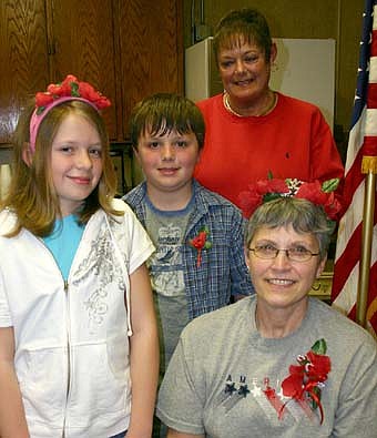 THE NEW QUEEN -- Sheila Majerus, seated at right, was selected as the 2008 poppy queen by the members of the Stewartville American Legion Auxiliary Unit 164 last week. Standing, from left, are Laura Eberle, poppy princess; Travis Capelle, poppy prince; and  Peggy Paulson, chair of the Legion Auxiliary's poppy committee.  