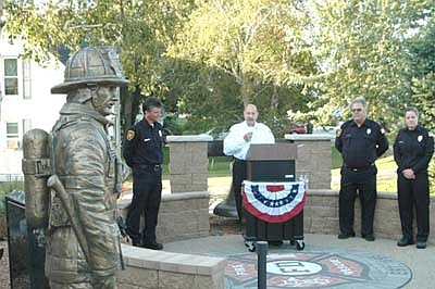 Steve Wolf, assistant fire chief, standing at the podium, was the opening speaker as the Stewartville Fire Department dedicated its new memorial near the Stewartville Fire Hall on Patriot Day, Tuesday, Sept. 11.