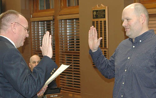 Josh Arndt, right, elected to a seat on the Stewartville City Council last November, takes the oath of office from Bill Schimmel Jr., city administrator, during the City Council's first meeting of the new year on Tuesday evening, Jan. 8.